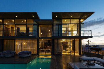 Luxury house with swimming pool illuminated at night