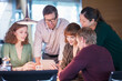 © Sam Edwards/KOTO - Business people using digital tablet in office meeting