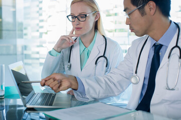 Wall Mural - Doctors using laptop and discuss patient's treatment