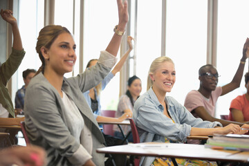 Wall Mural - University students raising hands during seminar