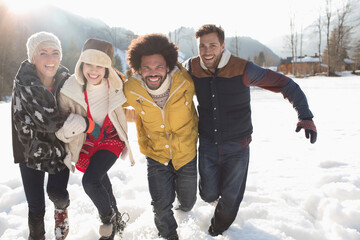 Friends running in snow