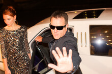 Bodyguard Protecting Celebrity From Paparazzi Outside Limousine At Event