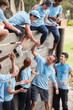 © Sam Edwards/KOTO - Teammates helping each other over wall on boot camp obstacle course