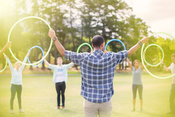 Wall Mural - Team connected in circle with plastic hoops