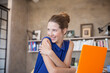 © Sam Edwards/KOTO - Portrait of young woman with orange laptop sitting in studio