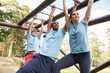 © Sam Edwards/KOTO - People crossing monkey bars on boot camp obstacle course