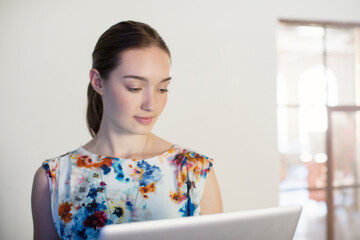 Wall Mural - Businesswoman working at laptop in office