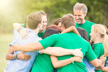 Wall Mural - Team hugging in huddle