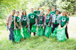 © Robert Daly/KOTO - Portrait of smiling environmentalist volunteers picking up trash