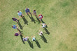 © Martin Barraud/KOTO - Overhead view of team connected in circle around plastic hoop