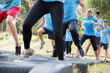 © Sam Edwards/KOTO - Determined people jumping tires on boot camp obstacle course