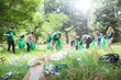 © Robert Daly/KOTO - Environmentalist volunteers picking up trash in field