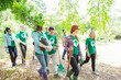 © Robert Daly/KOTO - Smiling environmentalist volunteers planting new tree