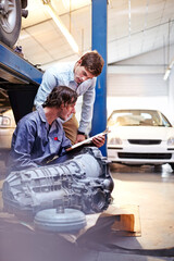 Wall Mural - Mechanic with clipboard talking to customer in auto repair shop