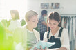 © Tom Merton/KOTO - Fashion designers reviewing paperwork in office