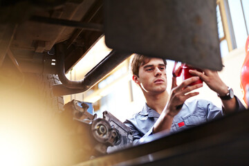 Wall Mural - Mechanic working in auto repair shop