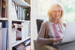 © Paul Bradbury/KOTO - Smiling senior woman using laptop in den