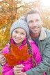 © Tom Merton/KOTO - Portrait father and daughter with autumn leaf hugging