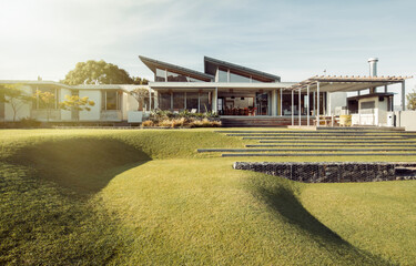 Sloped green yard and luxury house