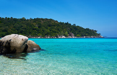 Tropical paradise beach with white sand and blue sky turquoise water and granite rocks travel tourism background concept. Amazing tropical holidays in paradise beaches of Tioman island, Malaysia.