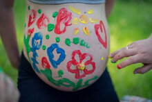 Little Boy Paints On His Mother’s Pregnant Belly