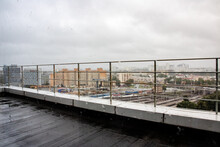 View Of The Rainy City And Balcony Railings