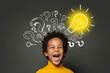 © millaf - Laughing child boy student with lightbulb and question marks. Brainstorming and idea concept