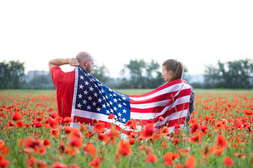 Couple holding the american flag on the 4th of July