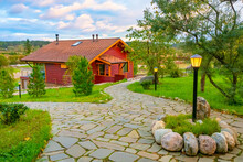 Wooden Cottage With A Large Veranda. Well-groomed Area Around The House. Natural Stone Paths And Lanterns. Stay In The Fresh Air. Family Vacation In Nature.