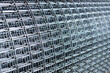 Roll of metal mesh with rectangular cells. Concept- construction, building materials. Selective focus.