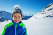 © Sergey Novikov - Happy boy in winter hat walking in sunny mountains close smiling portrait with copy space