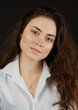 © Andrei Sasin - Portrait of a beautiful young woman with dark hair in a white shirt on a dark background