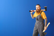 © Pixel-Shot - Handsome lumberjack on color background