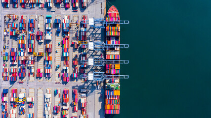 Wall Mural - Container ship at industrial port in import export global business worldwide logistic and transportation, Container ship unloading freight shipment, Aerial view container cargo vessel boat freight.