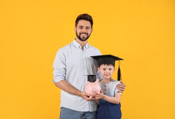 Sticker - Little boy and father with piggy bank on color background. Concept of savings for education