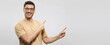 © Damir Khabirov - Banner of young smiling guy in beige t-shirt and eyewear, showing commercial offer on right, pointing to it with both hands, isolated on gray background