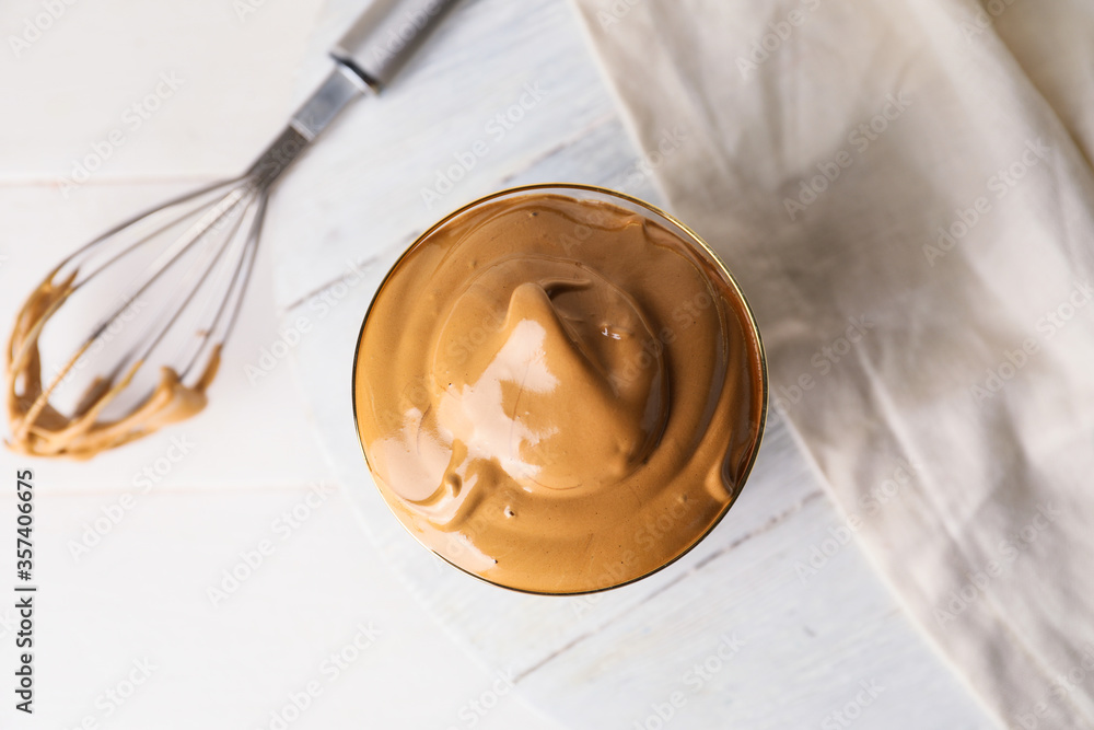 Glass of tasty dalgona coffee on table