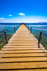 Wall Mural - Hard modern wooden bridge at popular tourist port