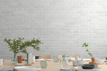 Blank White Brick Wall Mock Up In The Dinning Room With Served Table. 3d Render