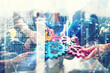 © alphaspirit - Working group of businessmen find the agreement by holding a piece of gear in hand. concept of teamwork and business partnership. double exposure with network effects