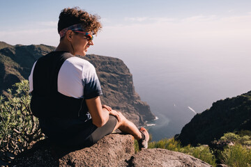 Portrait of young man resting after trail running