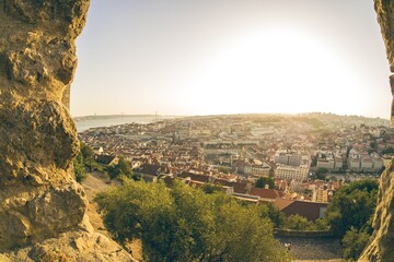 Canvas Print - Aerial view of a city in blooming vibrant colors with the sun shining high above