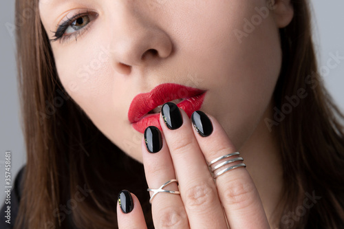 Vászonkép Beautiful young woman with bright makeup and black nail design