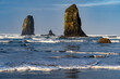 The Needles on Canon Beach in a rough sea with white capped waves and blue sky and clouds, Canon Beach, Oregon
