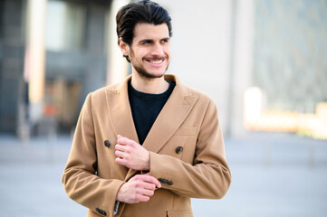 Handsome young man smiling outdoor in casual elegant cloths