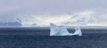 Iceberg In Dark Antarctic Ocean, Glacier Landscape And Mystic Clouds, Antarctica