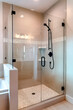 © Jason - Shower stall with half glass enclosure and black shower head and handle