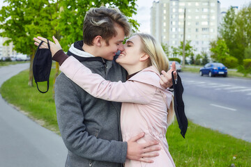 guy and girl kissing. expressing a desire to remove the mask and be free. the concept of freedom and relationships without protection