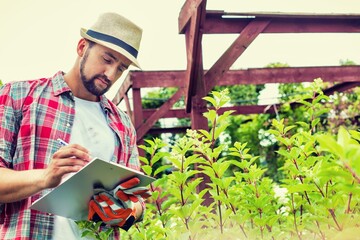 Wall Mural - Gardener working at garden centre