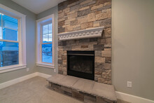 Modern Fireplace And Decorative Shelf Against Stone Brick Accent Wall Of Home